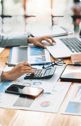businesswoman working in office using a calculator and a laptop