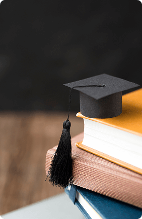 High angle small graduation cap-pile books