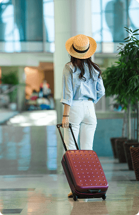 young woman walking with her luggage
